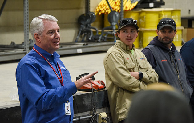 Brian Bird talks to employees in the Helena District Office.
